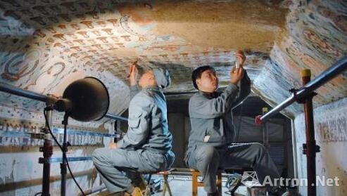两名工作人员在对莫高窟第85窟壁画进行修复(摄于2005年)